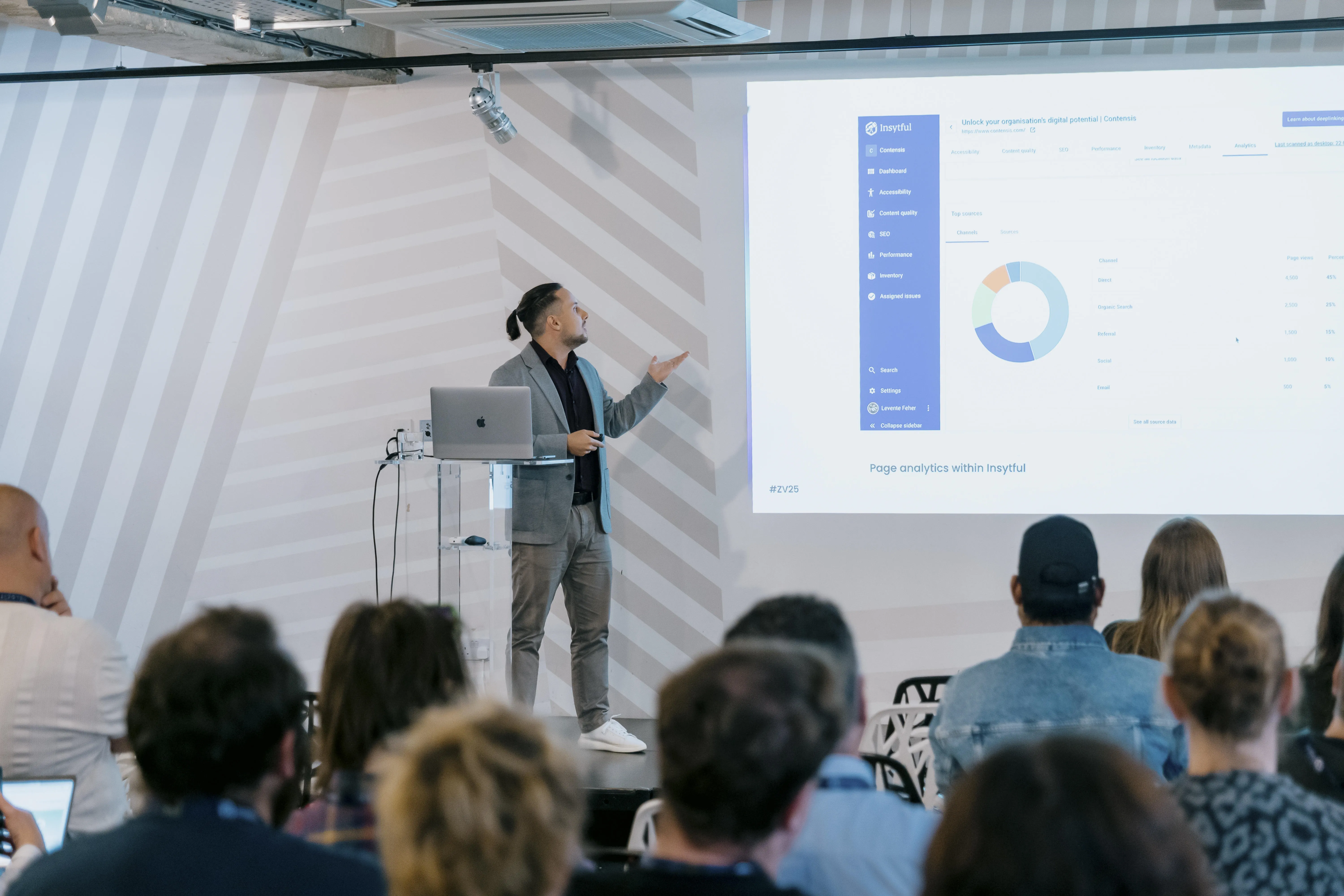 Insytful product manager, Levi, presenting on stage to a crowd at Velocity 2025